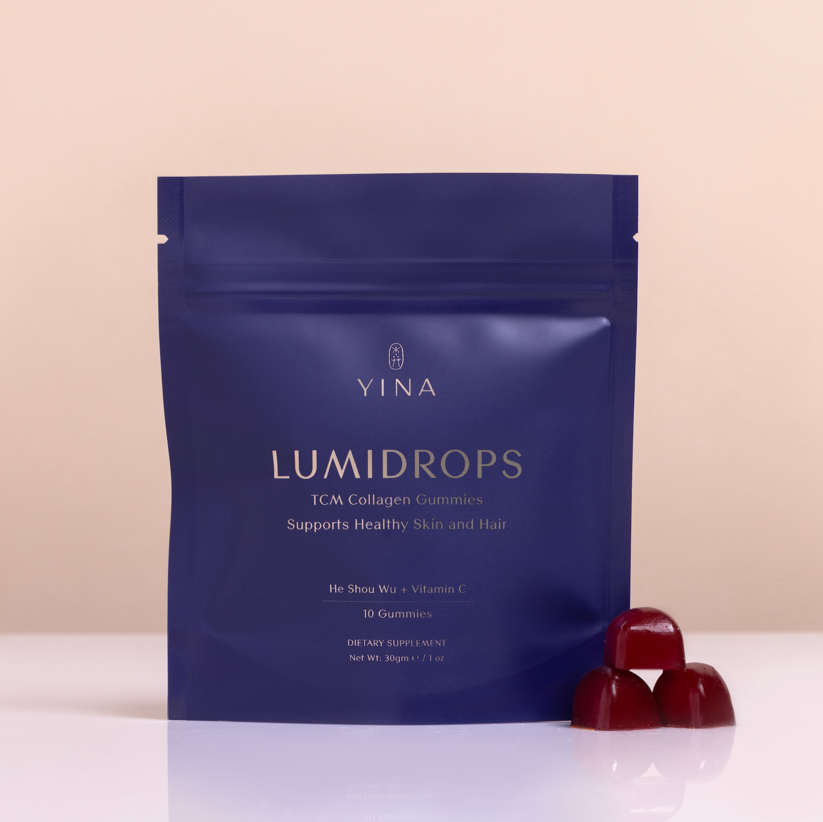 YINA Lumidrops package with two red gummies on a beige background